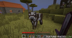 A 128x resolution Minecraft cow stares at the camera while a player points a Netherite sword at it in the savanna biome.